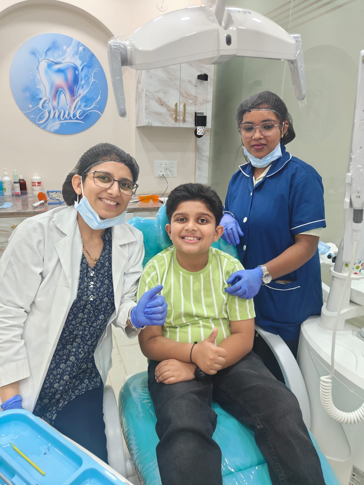 Happy young patient with the MIZ Dental care team
